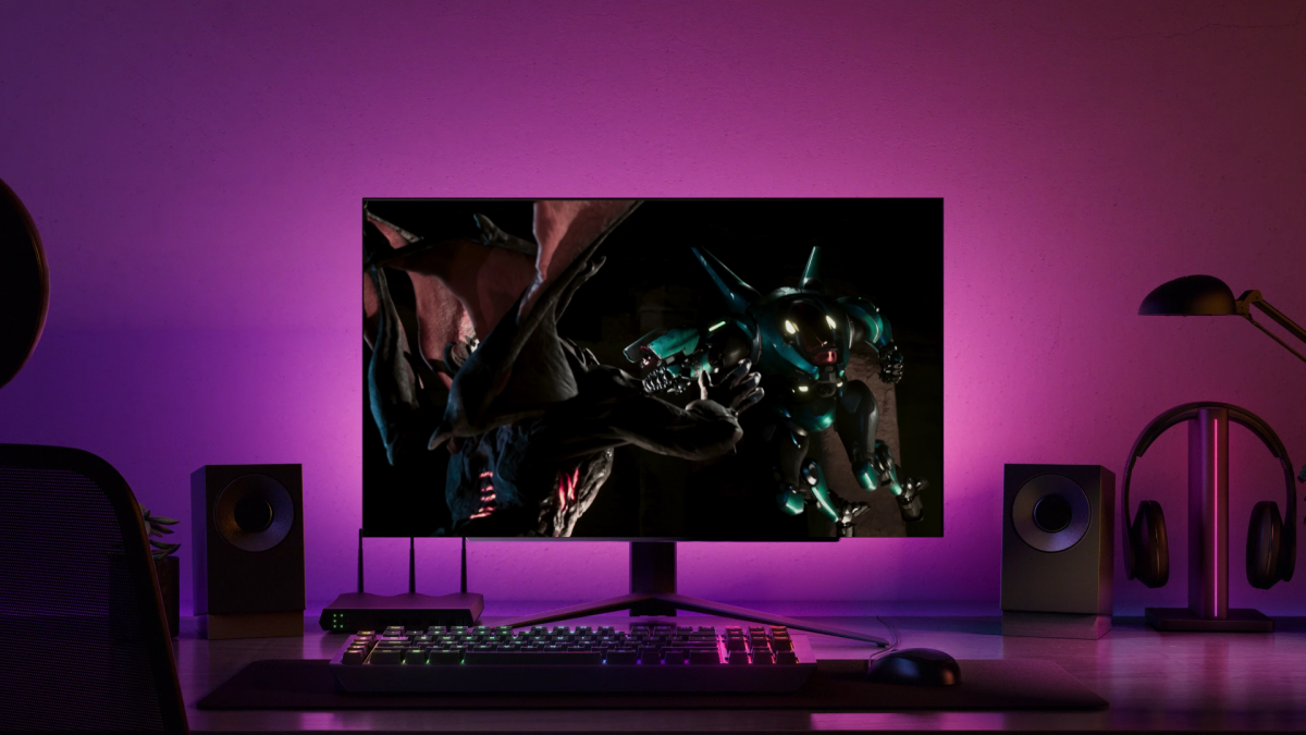 On a modern gaming desk bathed in purple light, an intense battle between a dragon and a mechanical robot comes to life on an LG Display gaming OLED.