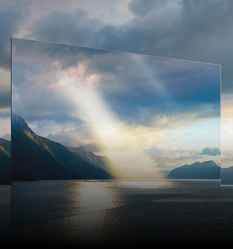 An OLED display floats in front of a lake and mountains with sunlight streaming through clouds, showing vivid, lifelike image quality.