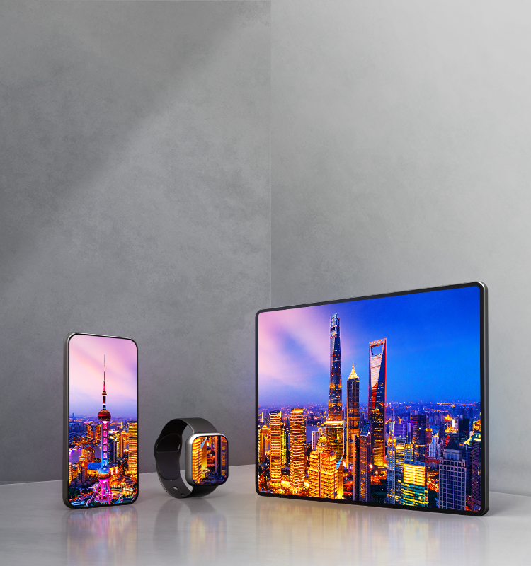 A smartphone, smartwatch, and tablet sit side-by-side on a gray background, all three displaying colorful nighttime photos on OLED displays.