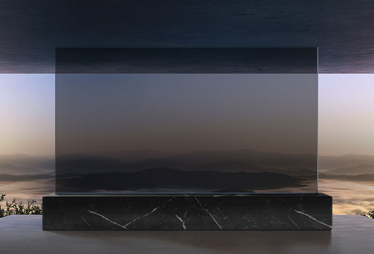 A large display sits on a black marble pedestal in the center of the room. An opaque black screen transitions to a translucent screen, with a view of the mountains and cloudy sky in the background beyond the display.